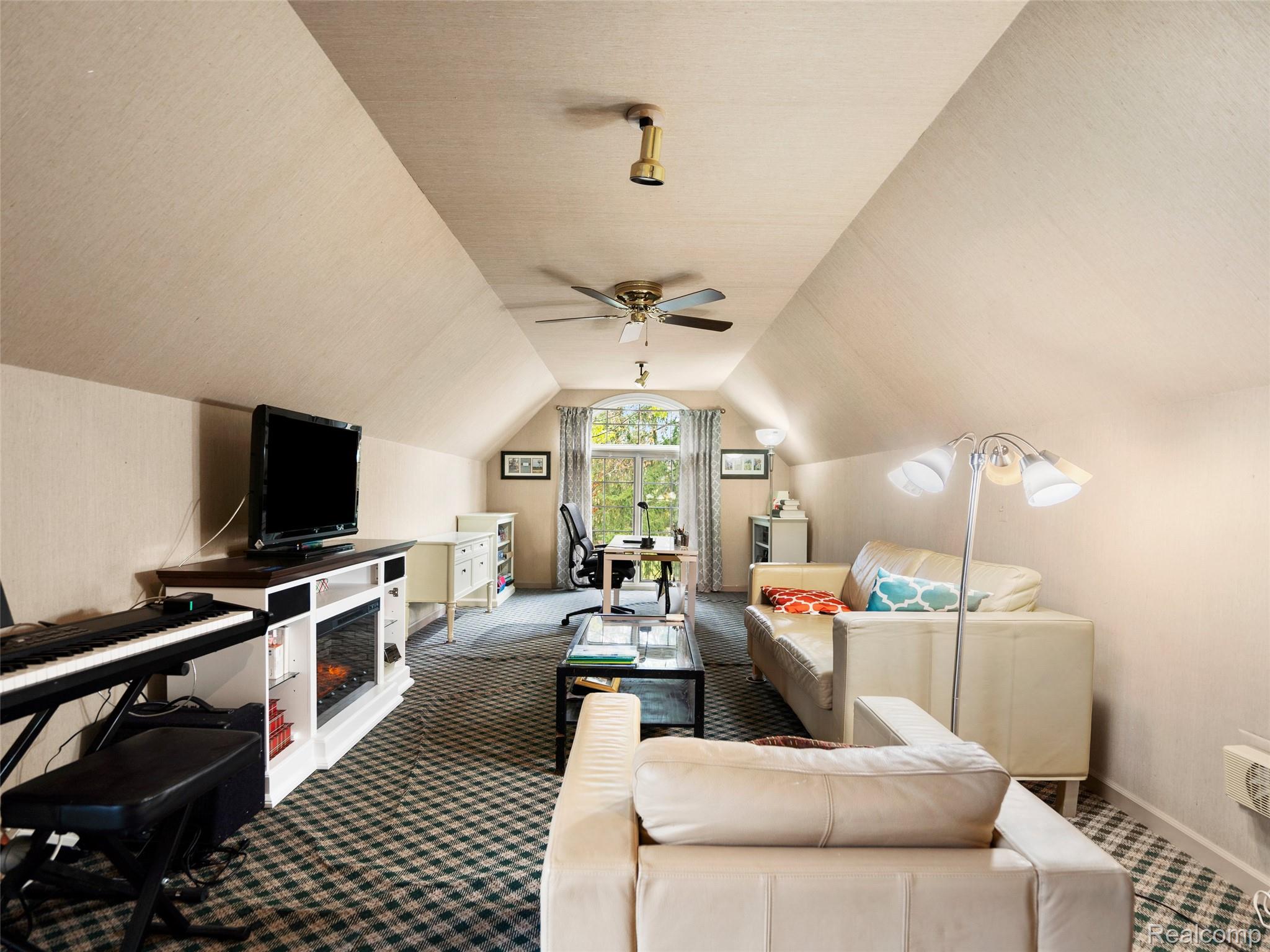 5724 Murfield Drive Rochester, MI 48306 - Photo 89 of 99 Carpeted living area featuring vaulted ceiling and a desk