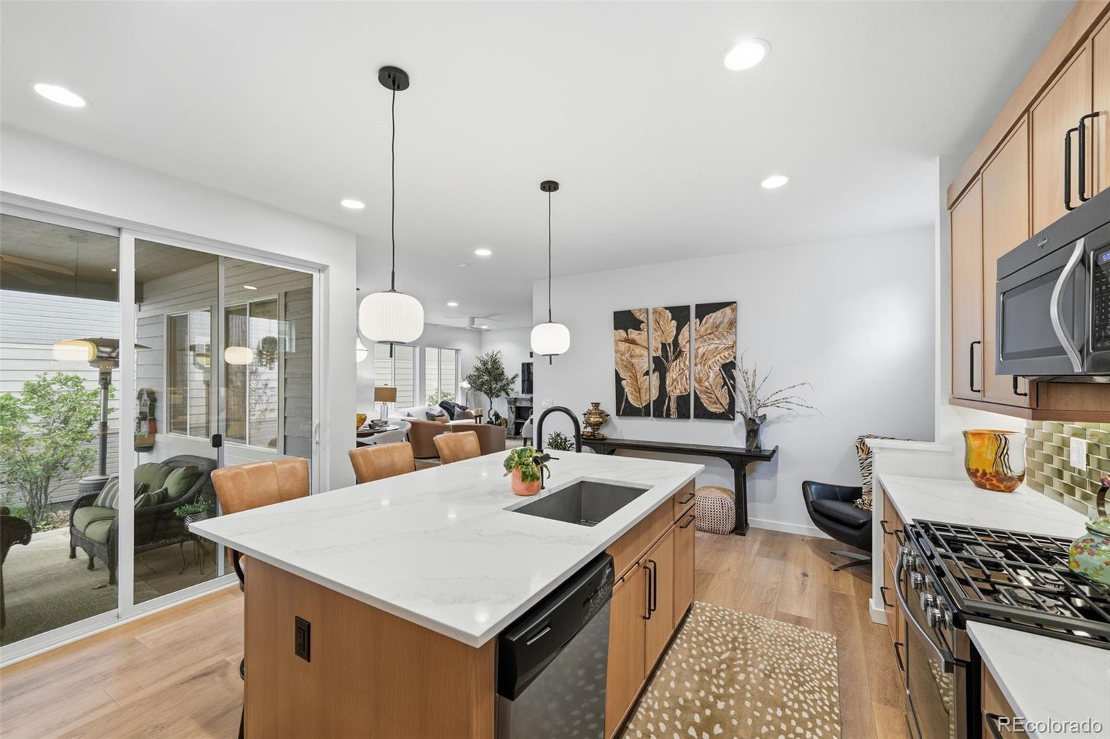 9602 Dunning Circle Highlands Ranch, CO 80126 - Photo 23 of 50 a view of a kitchen with kitchen island stainless steel appliances a sink table and chairs