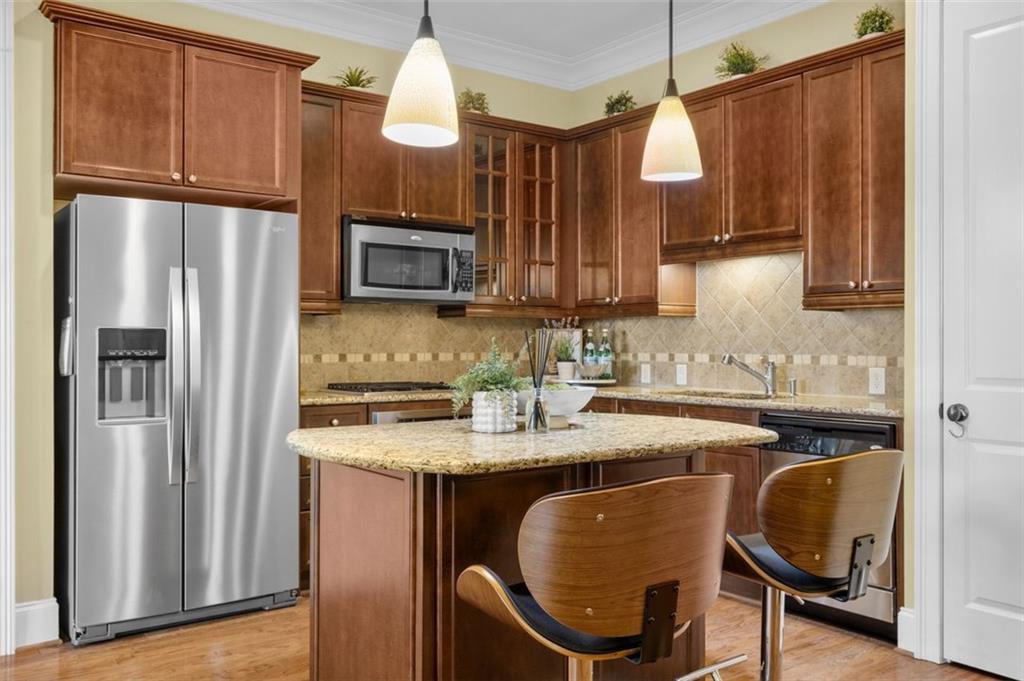 3635 East Paces Circle, Unit 1103 Atlanta, GA 30326 - Photo 13 of 37 a kitchen with stainless steel appliances granite countertop a sink refrigerator and microwave