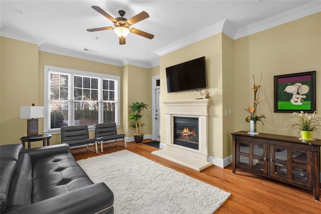 3635 East Paces Circle, Unit 1103 Atlanta, GA 30326 - Photo 14 of 37 a living room with furniture a flat screen tv and a fireplace