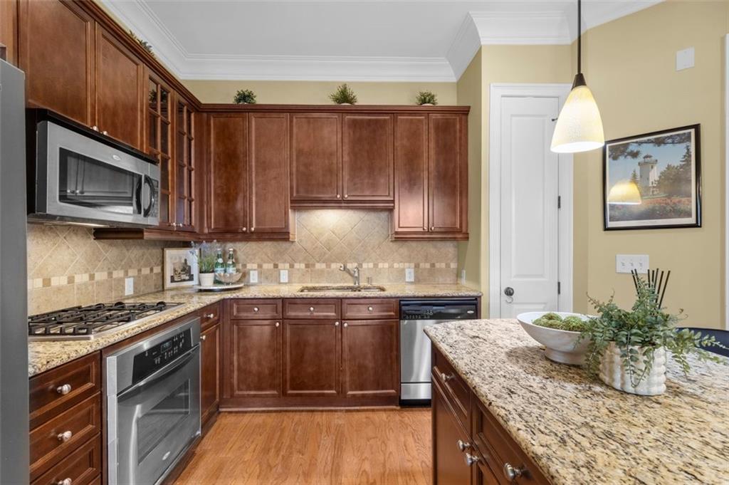 3635 East Paces Circle, Unit 1103 Atlanta, GA 30326 - Photo 18 of 37 a kitchen with stainless steel appliances granite countertop a sink stove and microwave