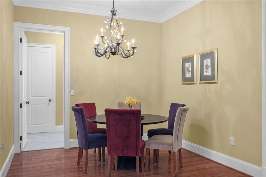 3635 East Paces Circle, Unit 1103 Atlanta, GA 30326 - Photo 19 of 37 a view of a dining room with furniture wooden floor and chandelier