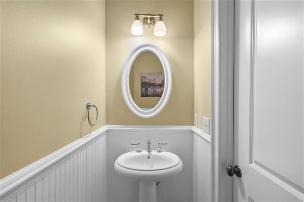 3635 East Paces Circle, Unit 1103 Atlanta, GA 30326 - Photo 20 of 37 a bathroom with a sink and a mirror