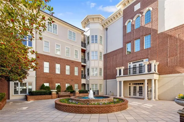 a kitchen with stainless steel appliances granite countertop a refrigerator a stove a sink dishwasher and a refrigerator with wooden floor