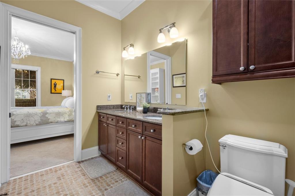 3635 East Paces Circle, Unit 1103 Atlanta, GA 30326 - Photo 23 of 37 a spacious bathroom with a granite countertop sink and a mirror