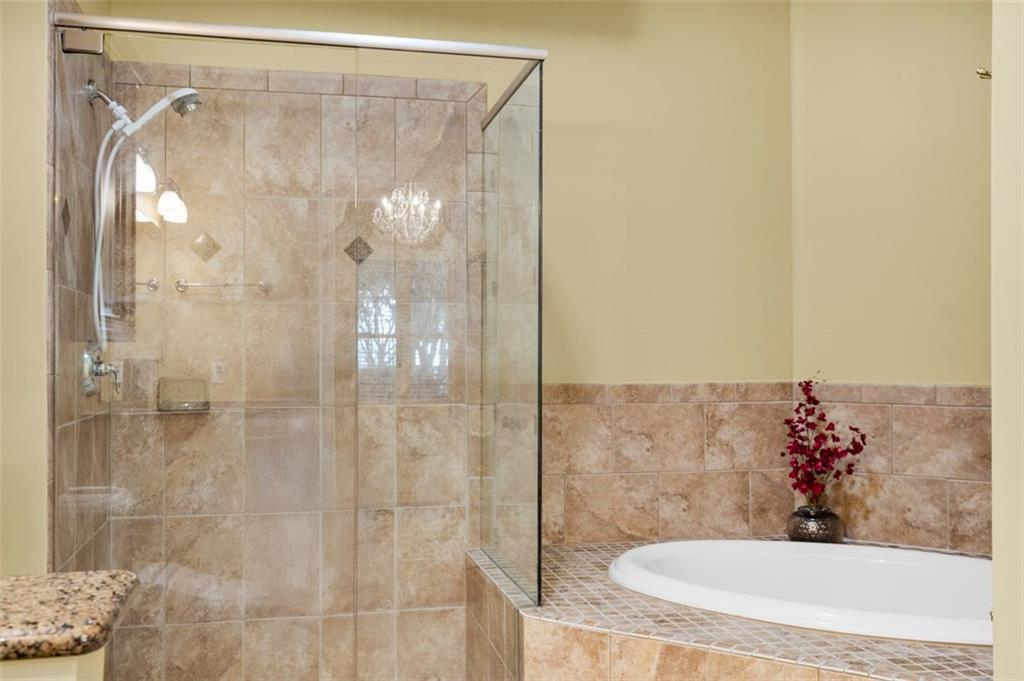 3635 East Paces Circle, Unit 1103 Atlanta, GA 30326 - Photo 24 of 37 a bathroom with a shower and a sink