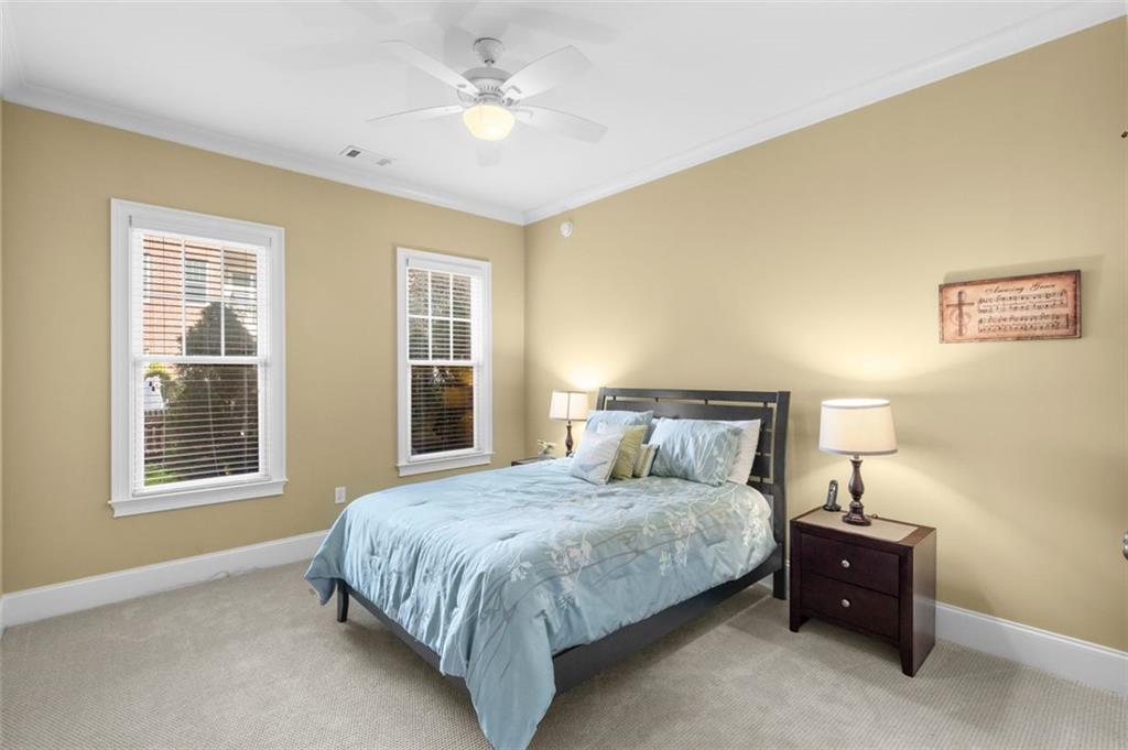 3635 East Paces Circle, Unit 1103 Atlanta, GA 30326 - Photo 27 of 37 a bedroom with a bed and a chandelier