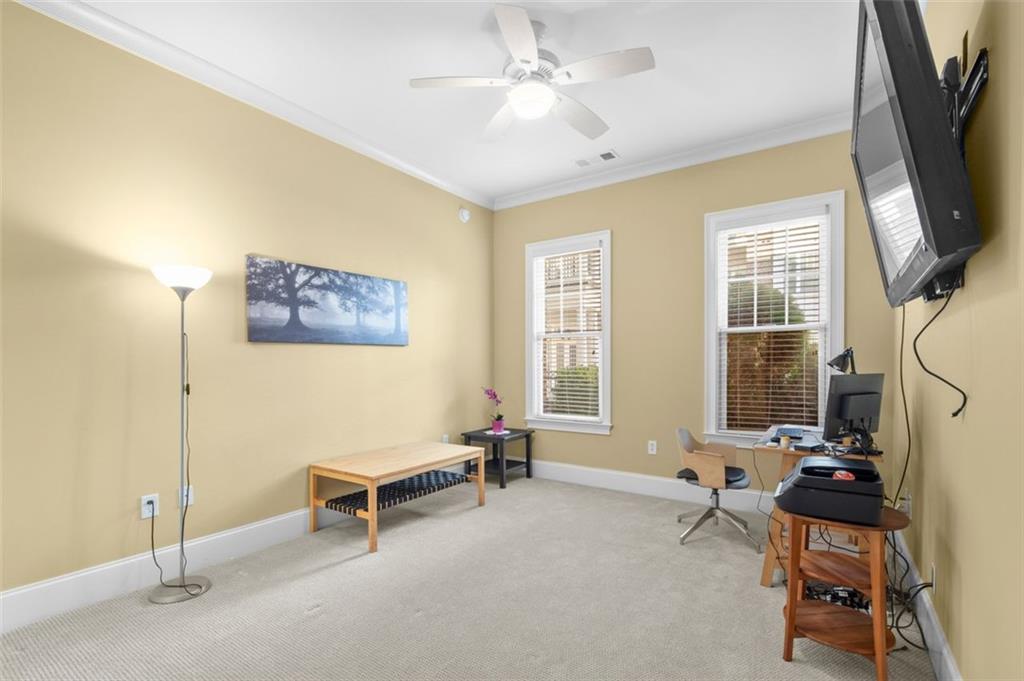 3635 East Paces Circle, Unit 1103 Atlanta, GA 30326 - Photo 30 of 37 a living room with furniture a flat screen tv and a window