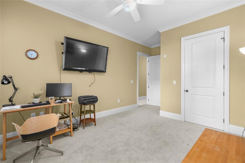 3635 East Paces Circle, Unit 1103 Atlanta, GA 30326 - Photo 31 of 37 a livingroom with workspace and a flat screen tv