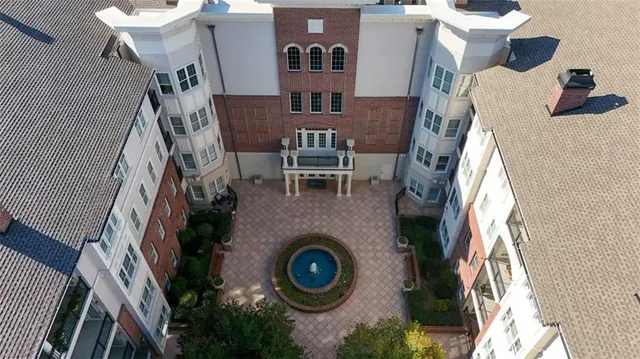 an aerial view of a house with a yard and mountain view
