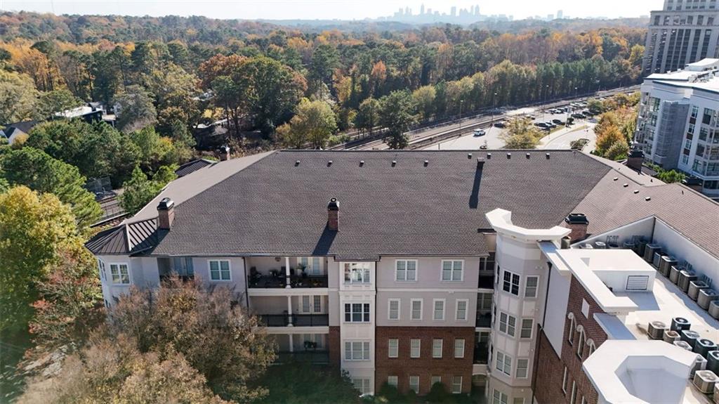 3635 East Paces Circle, Unit 1103 Atlanta, GA 30326 - Photo 36 of 37 an aerial view of a house with a yard and mountain view
