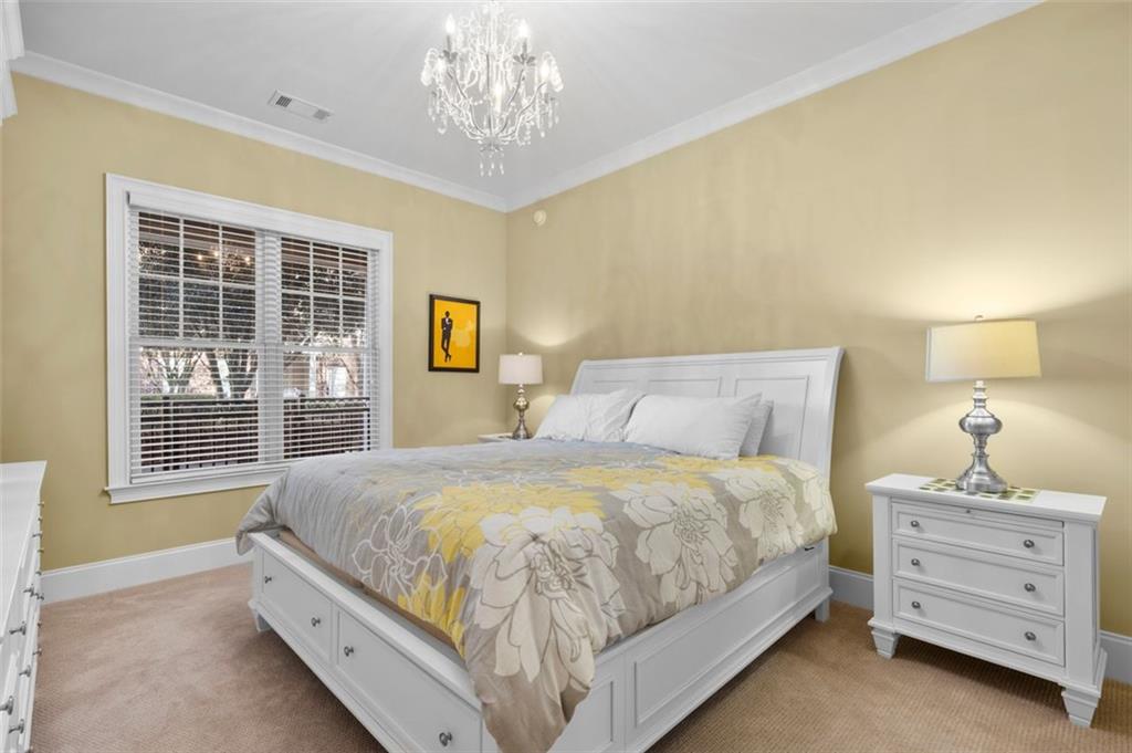 3635 East Paces Circle, Unit 1103 Atlanta, GA 30326 - Photo 4 of 37 a bedroom with a bed and a window