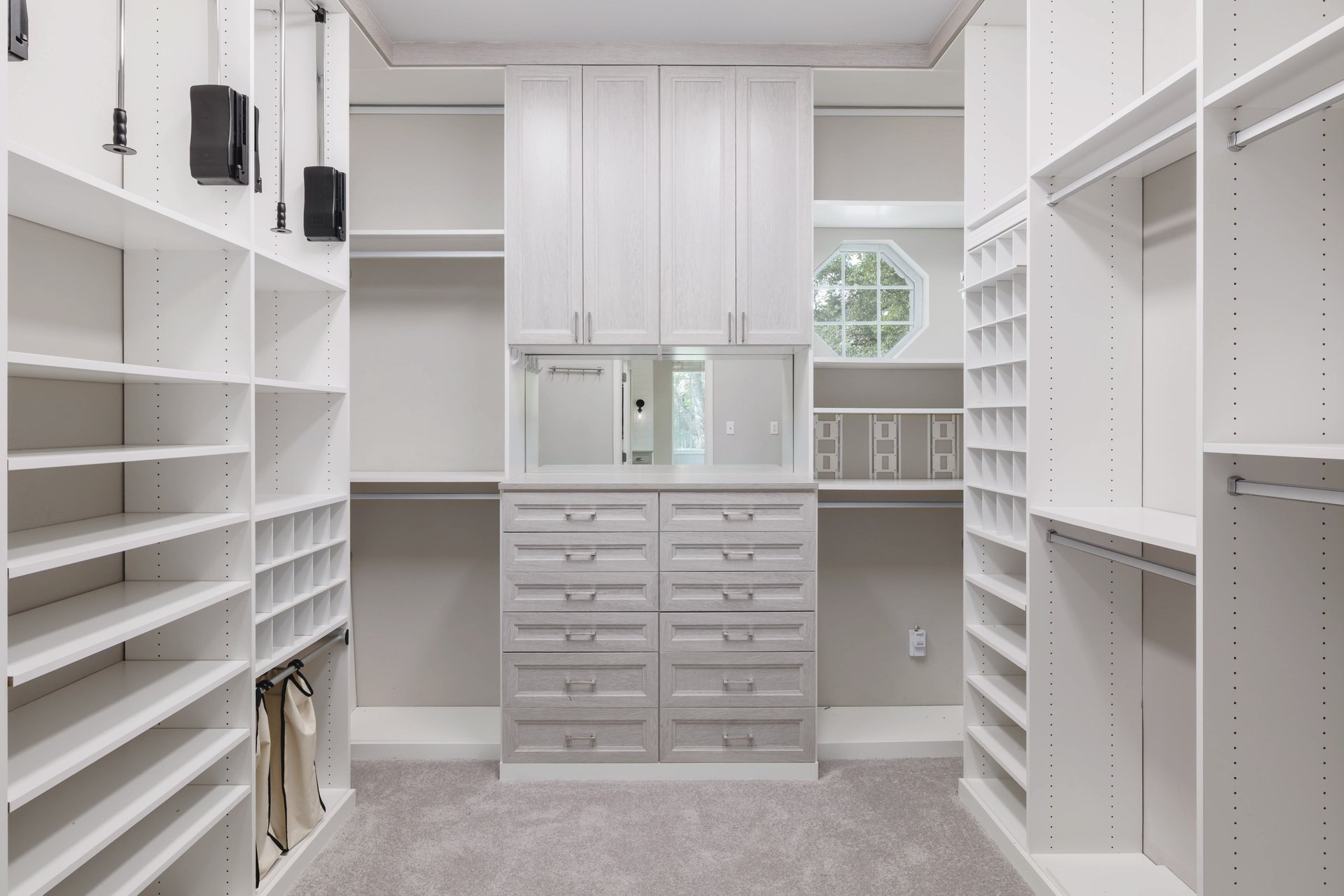 5512 Ballenton Lane Austin, TX 78739 - Photo 24 of 40 Ample built-in storage solutions and custom cabinetry organize this generously sized walk-in closet.