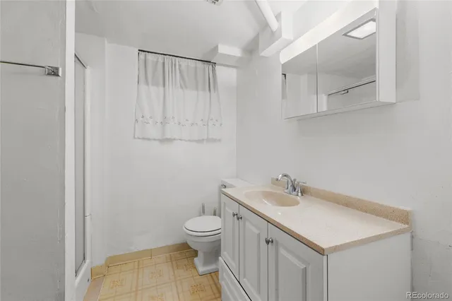 a bathroom with a sink a toilet and vanity