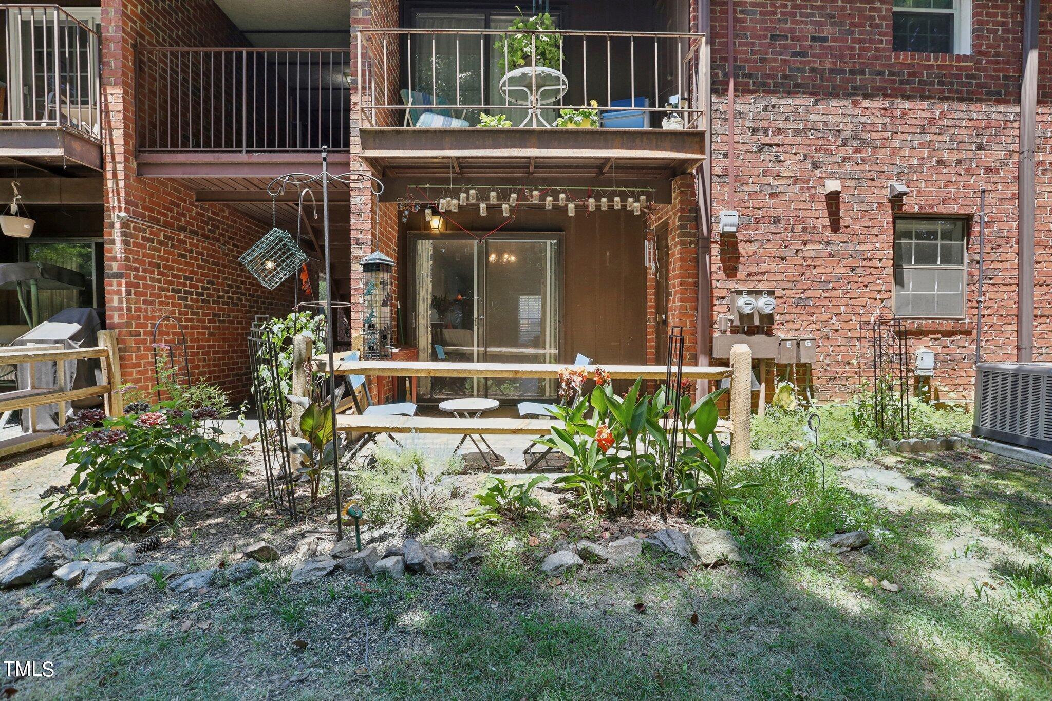 1216 Manassas Court, Unit E Raleigh, NC 27609 - Photo 18 of 20 a front view of a house with garden