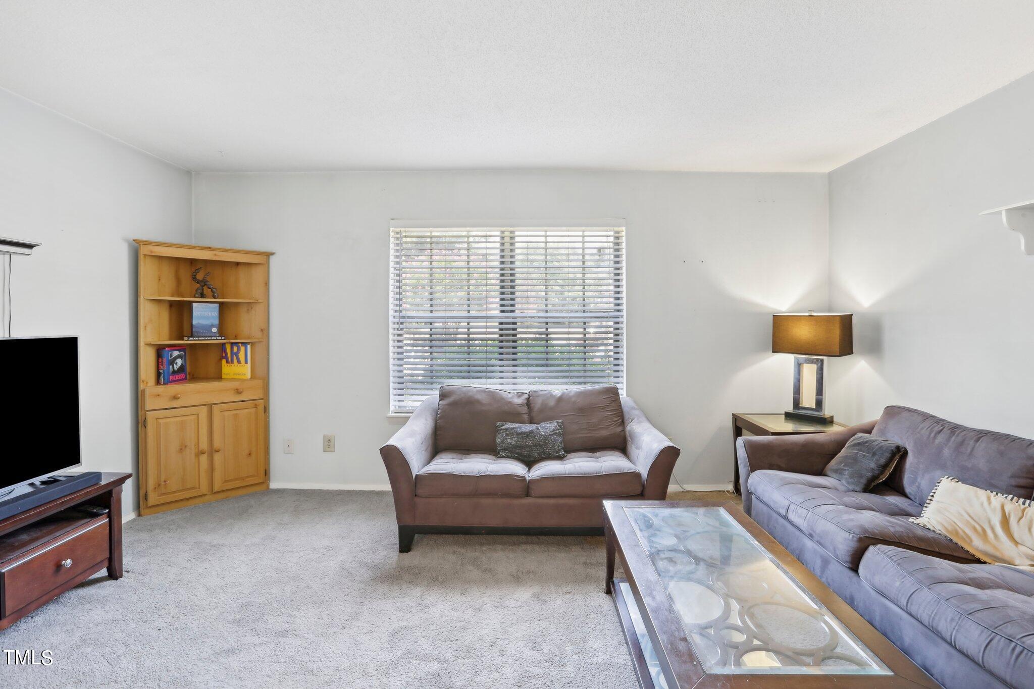 1216 Manassas Court, Unit E Raleigh, NC 27609 - Photo 4 of 20 a living room with furniture and a flat screen tv