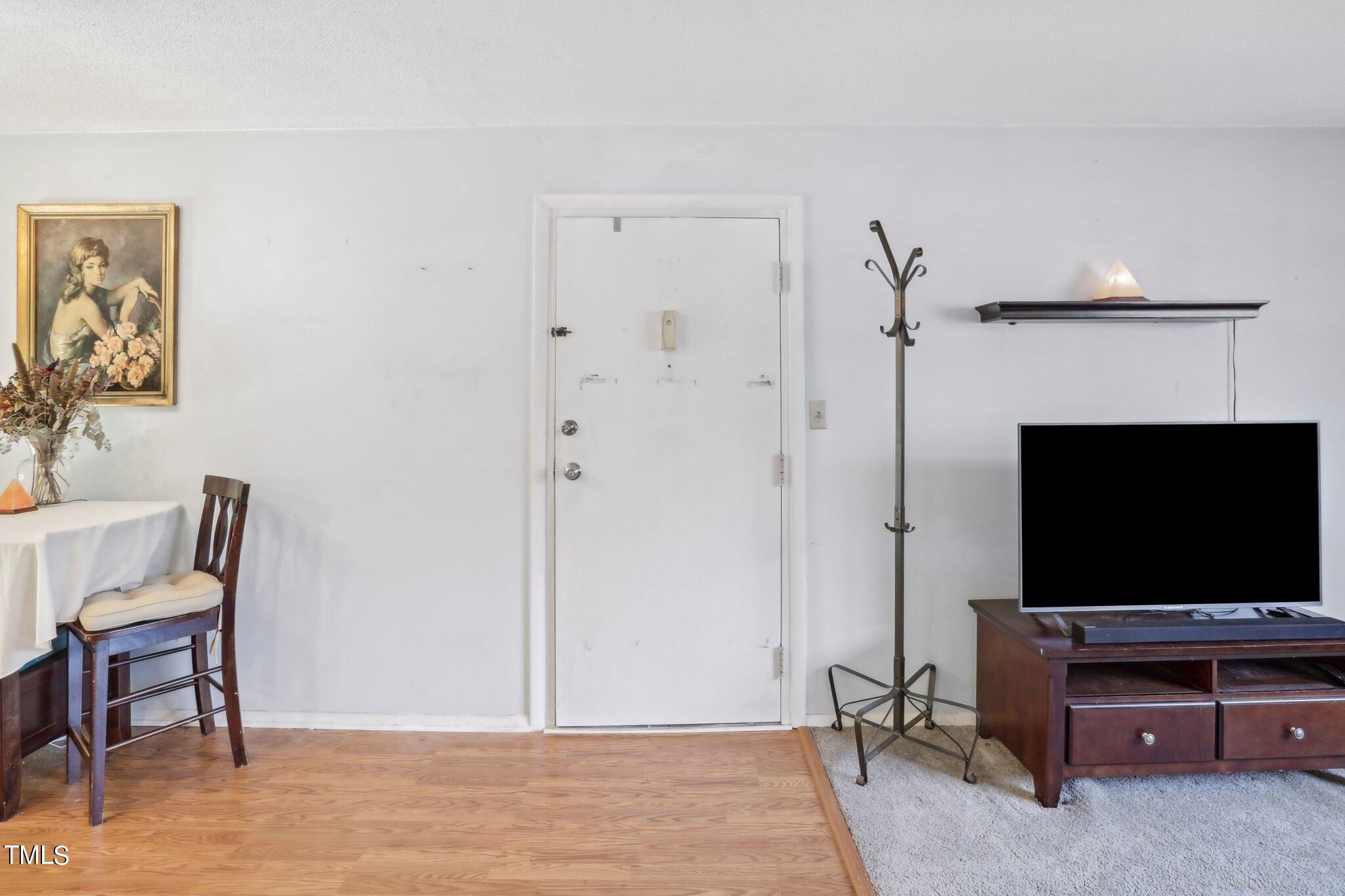 1216 Manassas Court, Unit E Raleigh, NC 27609 - Photo 5 of 20 a living room with furniture and a flat screen tv