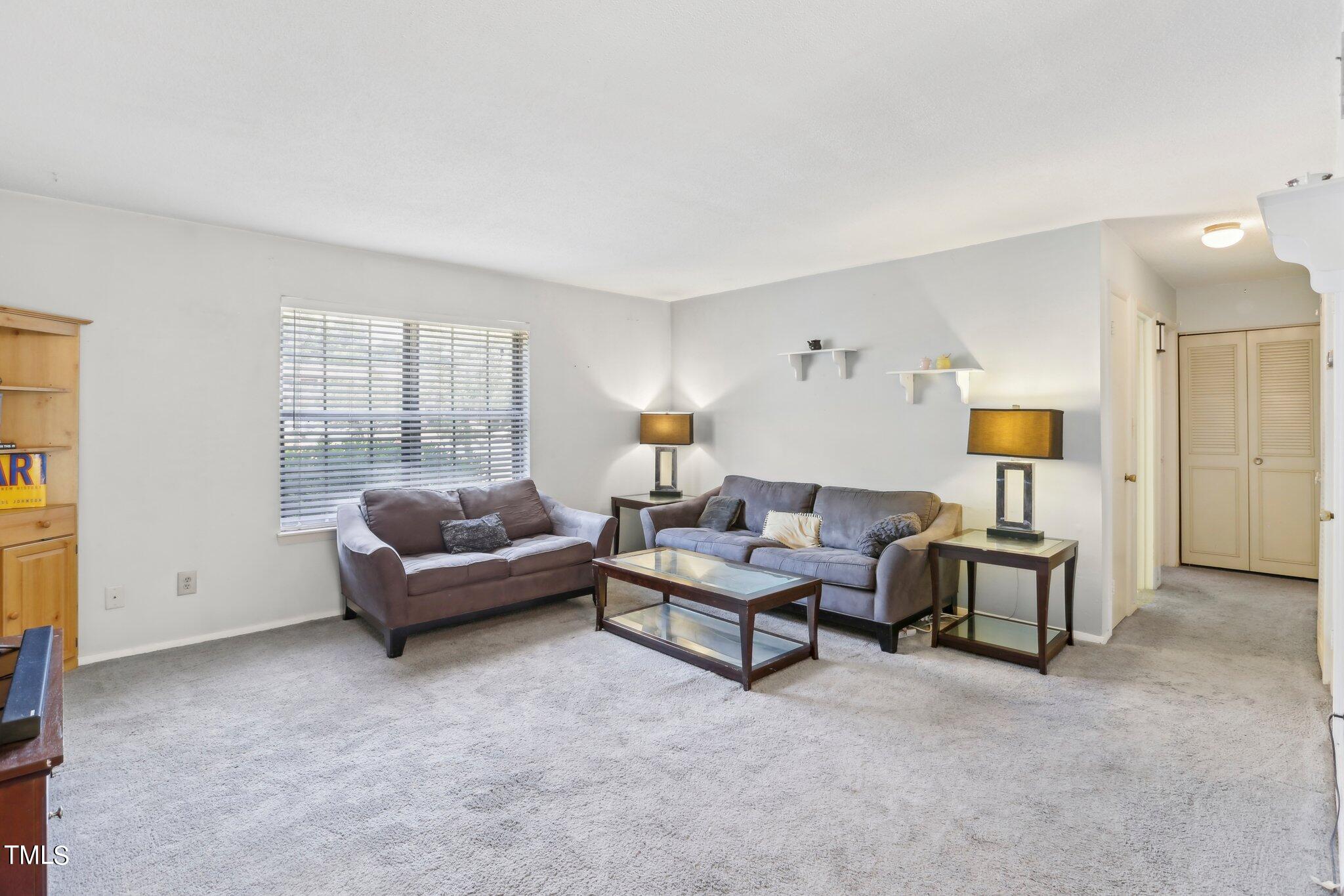 1216 Manassas Court, Unit E Raleigh, NC 27609 - Photo 6 of 20 a living room with furniture and a window