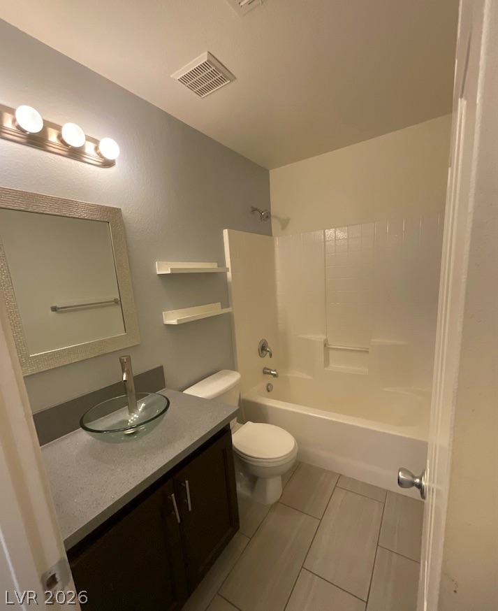 7203 Cestrum Road Las Vegas, NV 89113 - Photo 20 of 22 A modern bathroom features a stylish vessel sink vanity paired with a classic tiled tub.
