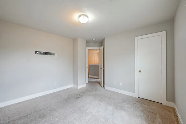 a view of an empty room and closet area