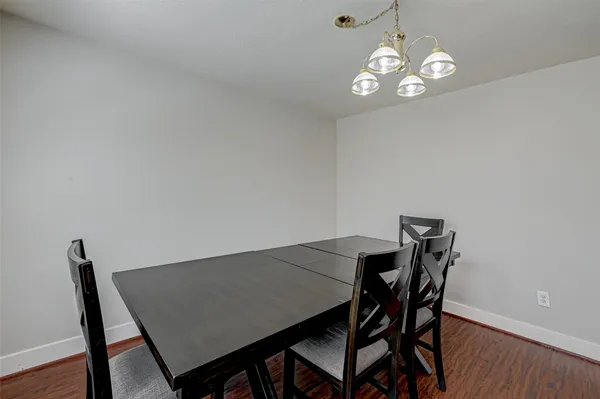 a view of a dining room with a table and chairs