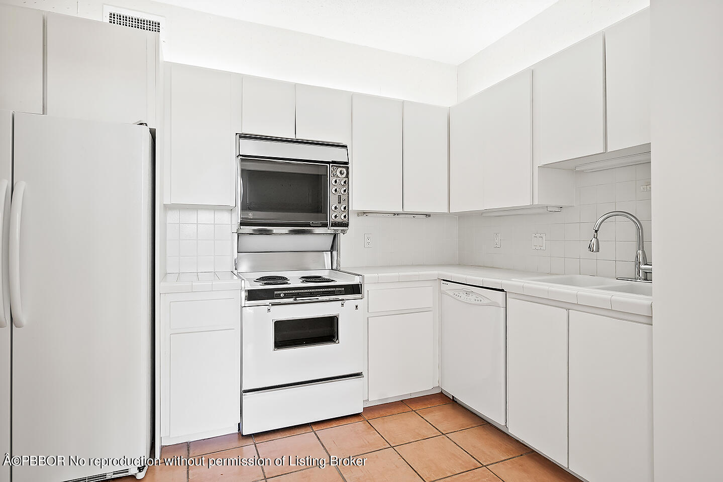 2150 Ibis Isle Road, Unit 17 Palm Beach, FL 33480 - Photo 11 of 55 a kitchen with a sink stove and microwave