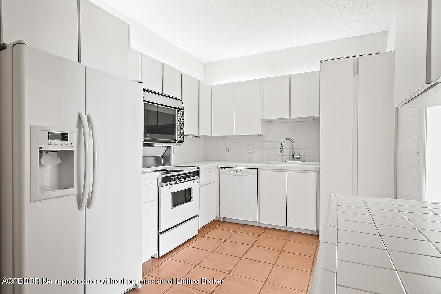 2150 Ibis Isle Road, Unit 17 Palm Beach, FL 33480 - Photo 12 of 55 a kitchen with white cabinets and stainless steel appliances