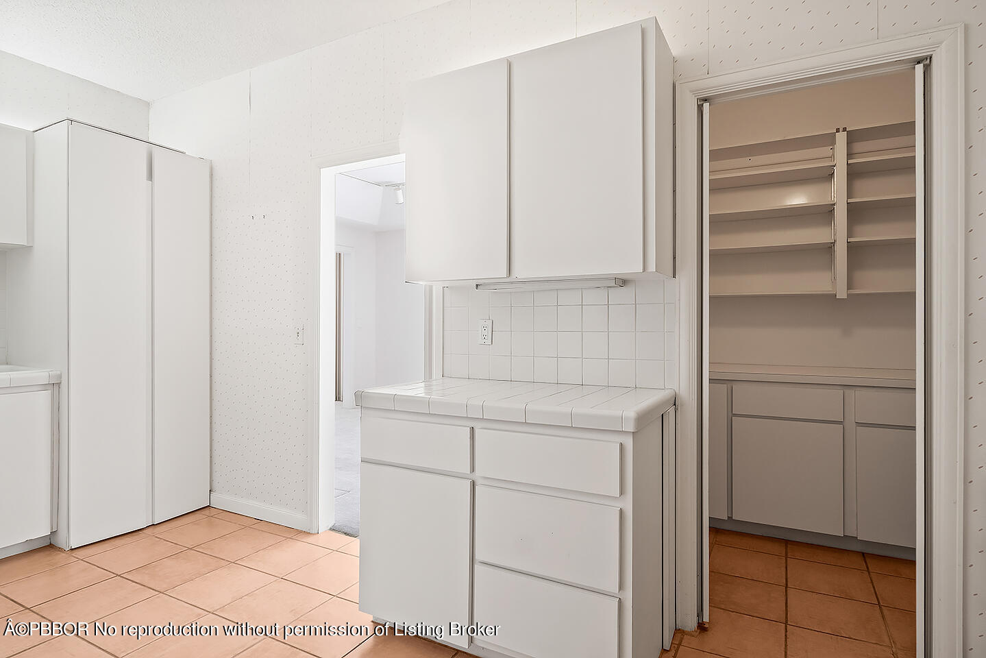 2150 Ibis Isle Road, Unit 17 Palm Beach, FL 33480 - Photo 13 of 55 a kitchen with white cabinets and white appliances
