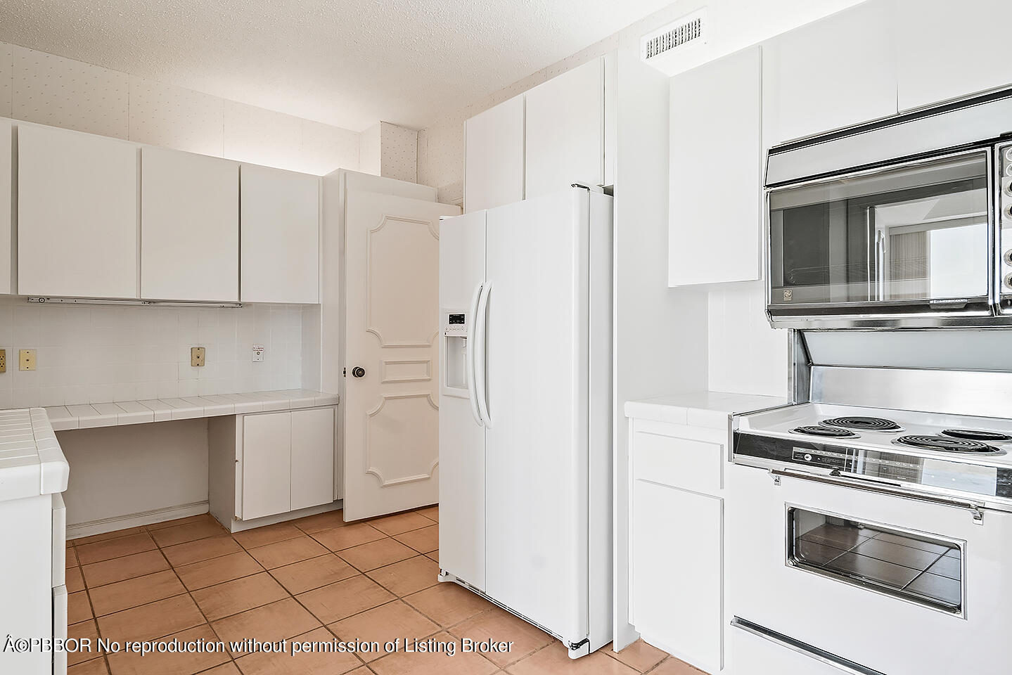 2150 Ibis Isle Road, Unit 17 Palm Beach, FL 33480 - Photo 14 of 55 a kitchen with stainless steel appliances a stove a microwave and a refrigerator