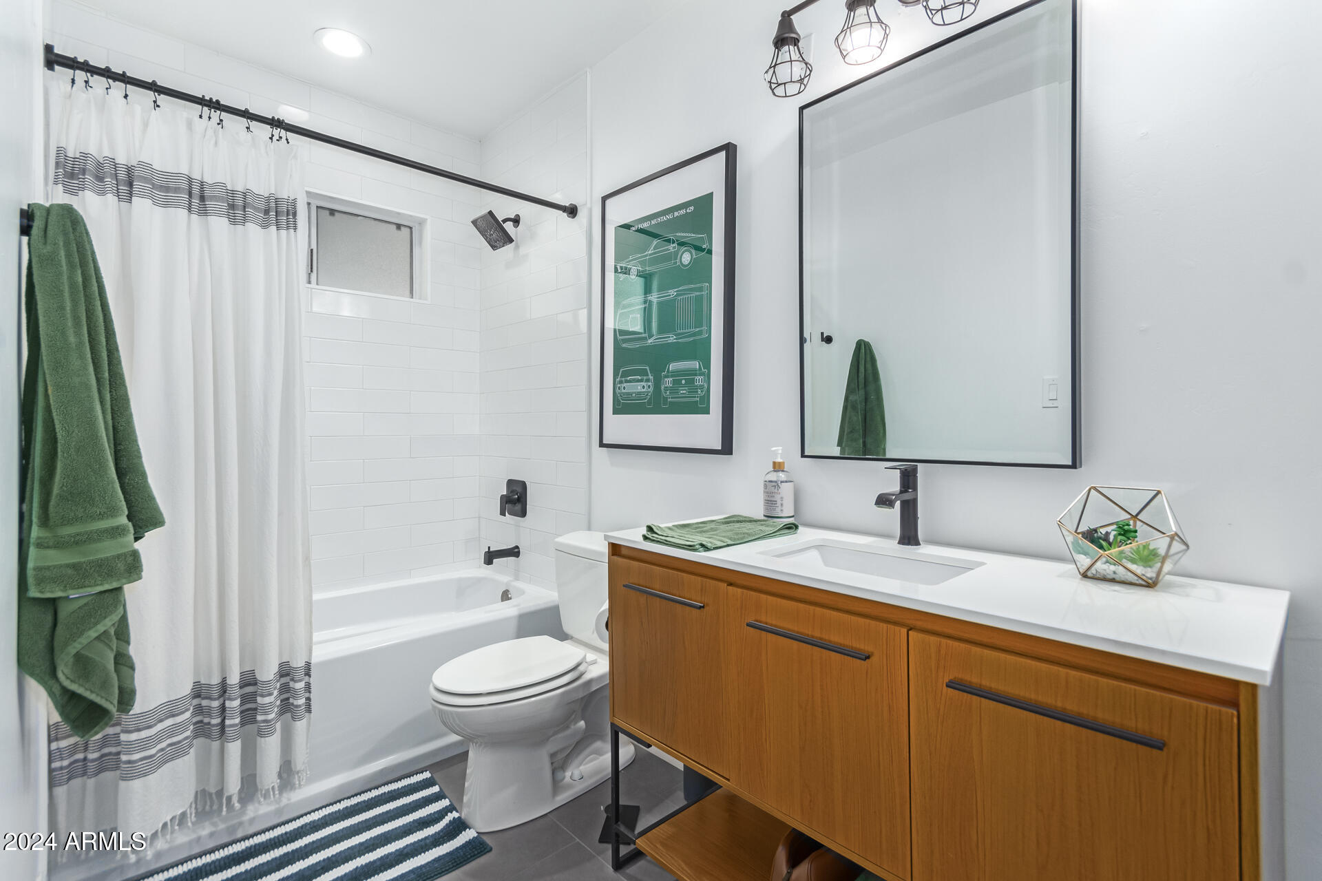 744 West Royal Palm Road Phoenix, AZ 85021 - Photo 28 of 65 a bathroom with a granite countertop sink toilet a mirror and bathtub