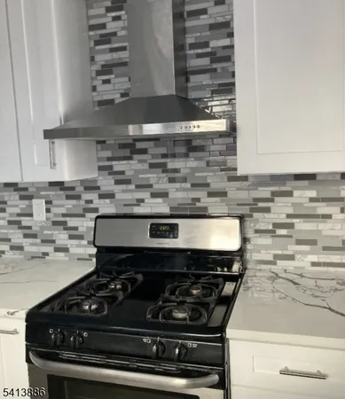 a stove top oven sitting inside of a kitchen