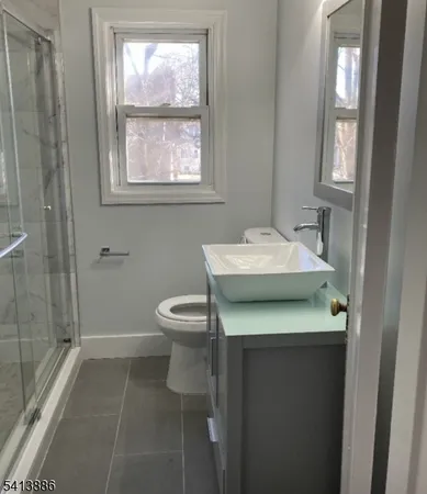 a bathroom with a sink toilet and window