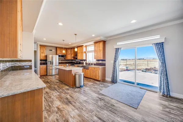 a large kitchen with cabinets and wooden floor