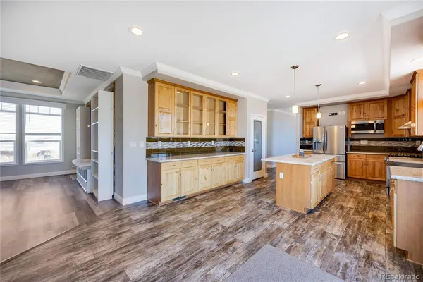 a kitchen with stove top oven and refrigerator
