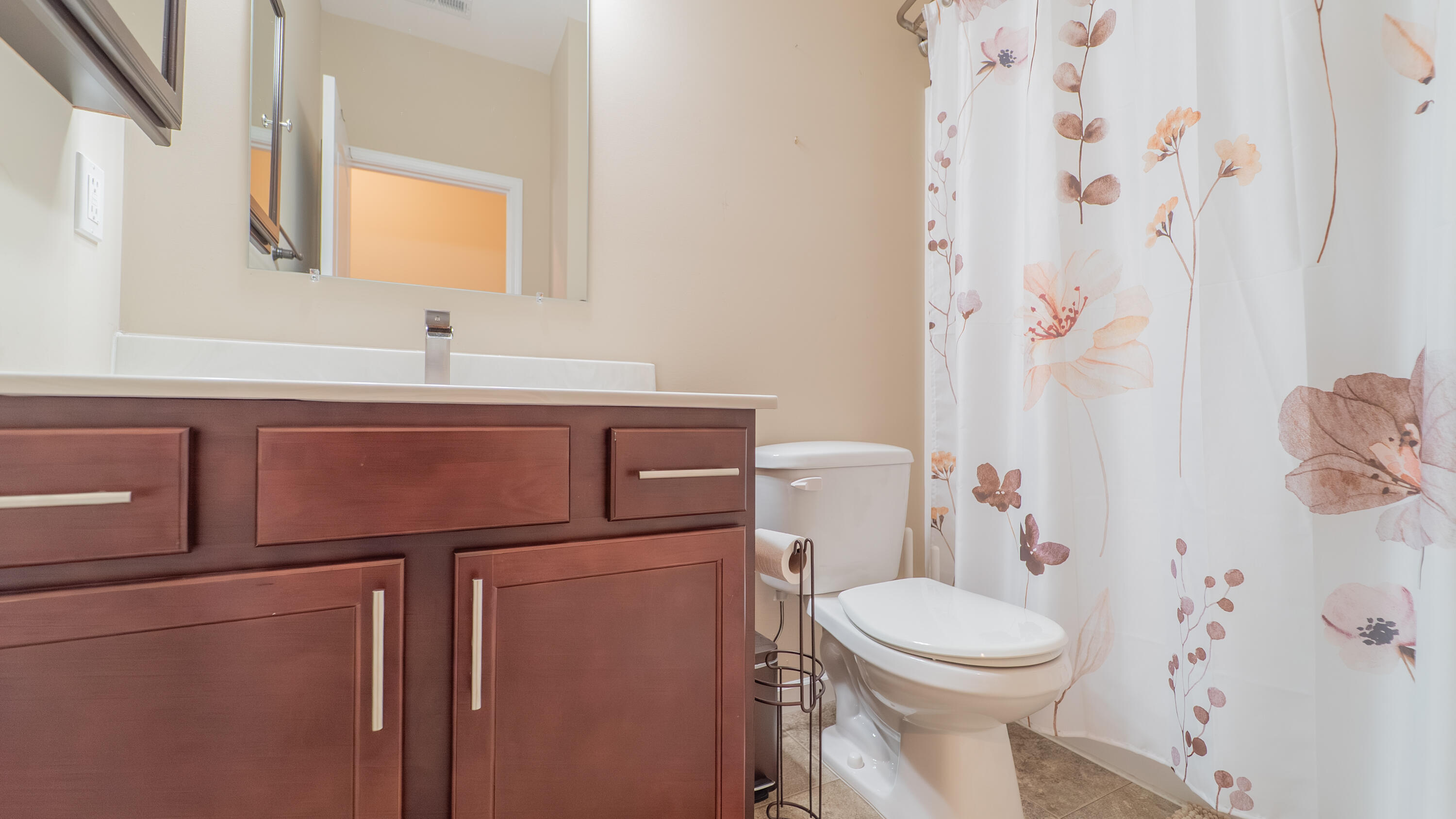 11530 Vermont Court Crown Point, IN 46307 - Photo 23 of 27 a bathroom with a sink a toilet and shower curtain