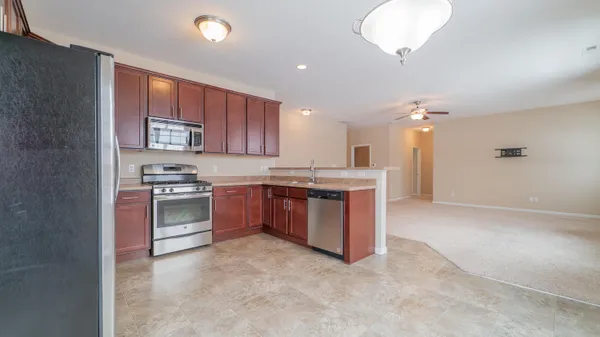 a kitchen with stainless steel appliances granite countertop a stove sink and cabinets