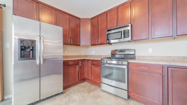 a kitchen with stainless steel appliances granite countertop a refrigerator and cabinets