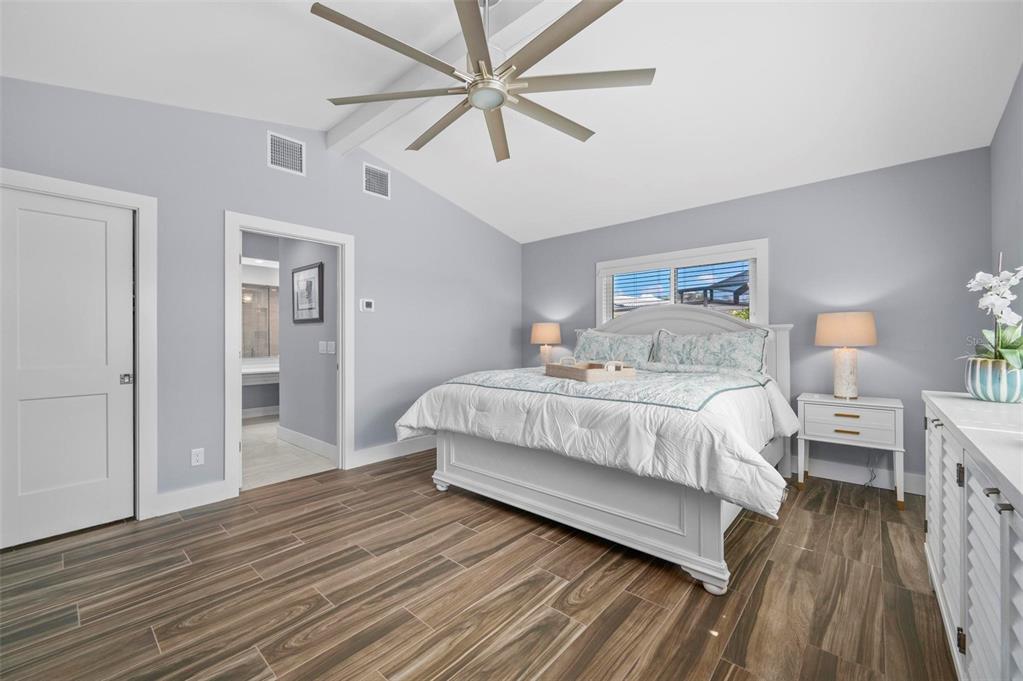 75 Spyglass Alley Placida, FL 33946 - Photo 24 of 79 a bed room with a bed and a chandelier