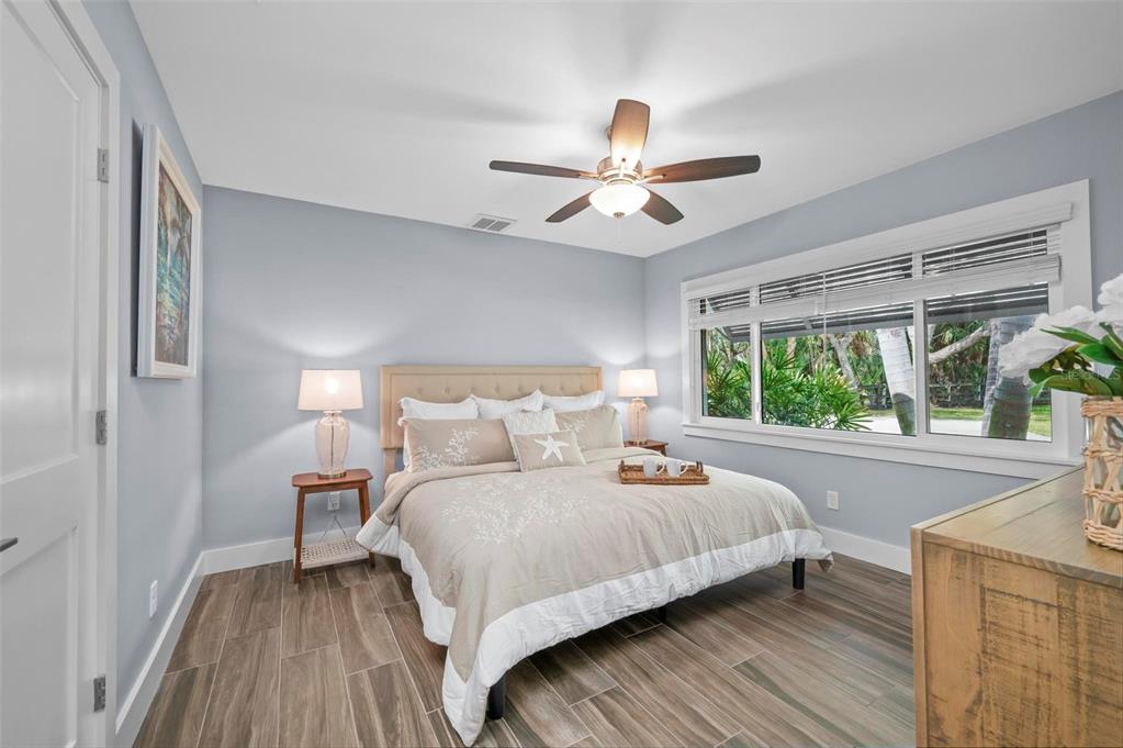 75 Spyglass Alley Placida, FL 33946 - Photo 30 of 79 a bedroom with a bed and a large window