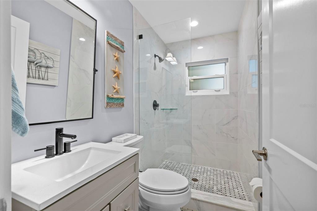 75 Spyglass Alley Placida, FL 33946 - Photo 37 of 79 a bathroom with a sink toilet and shower