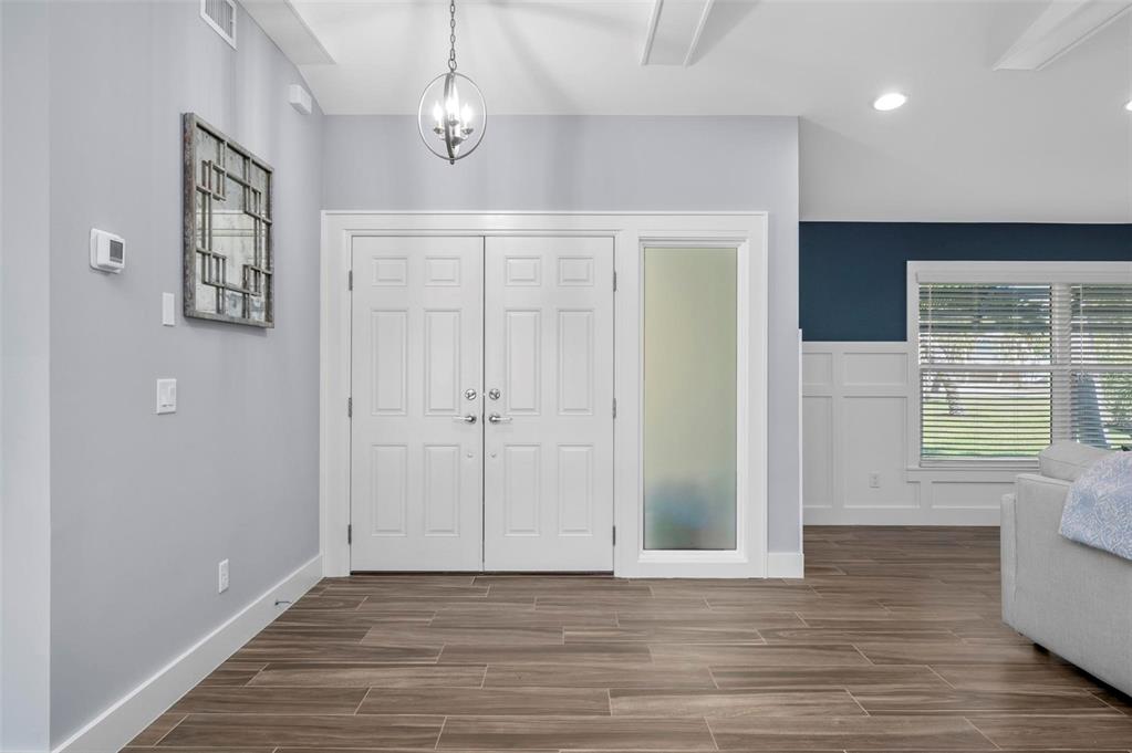 75 Spyglass Alley Placida, FL 33946 - Photo 5 of 79 wooden floor in an empty room with a window