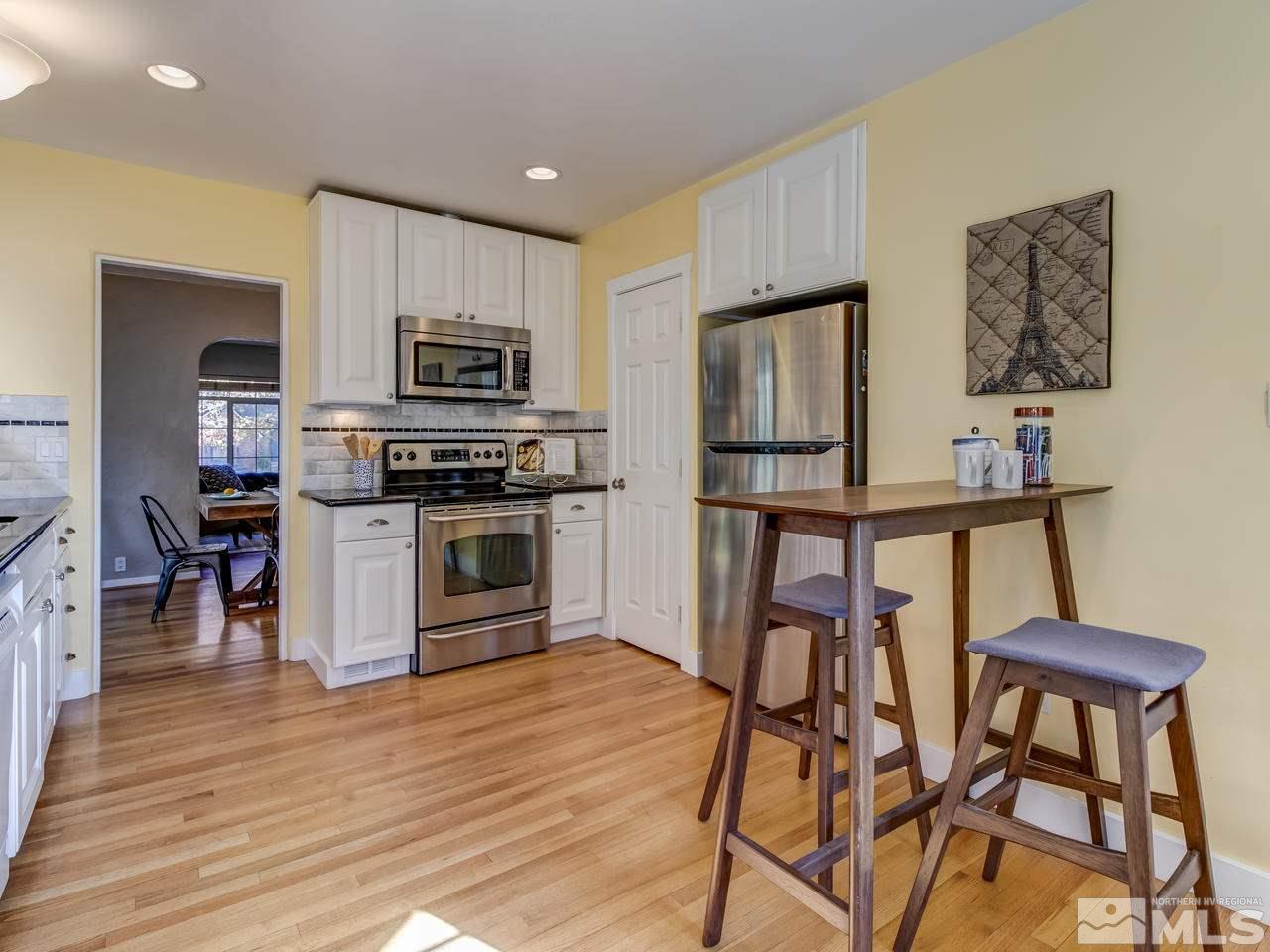950 Walker Avenue Reno, NV 89509 - Photo 12 of 25 a kitchen with stainless steel appliances wooden floor and a refrigerator