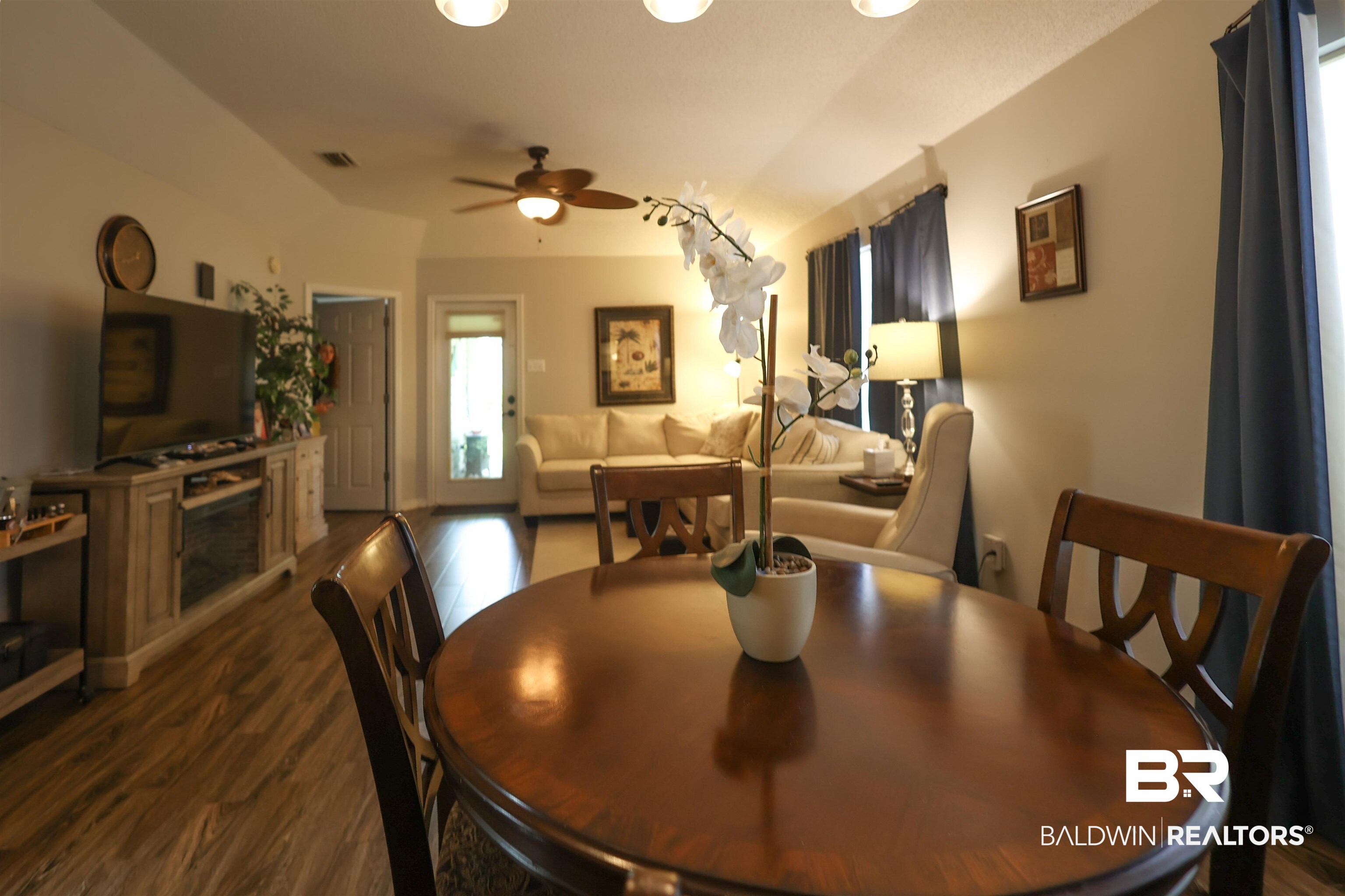 7790 Audubon Drive Foley, AL 36535 - Photo 14 of 39 Open-concept living space featuring wood-finish flooring, a vaulted ceiling, and a ceiling fan