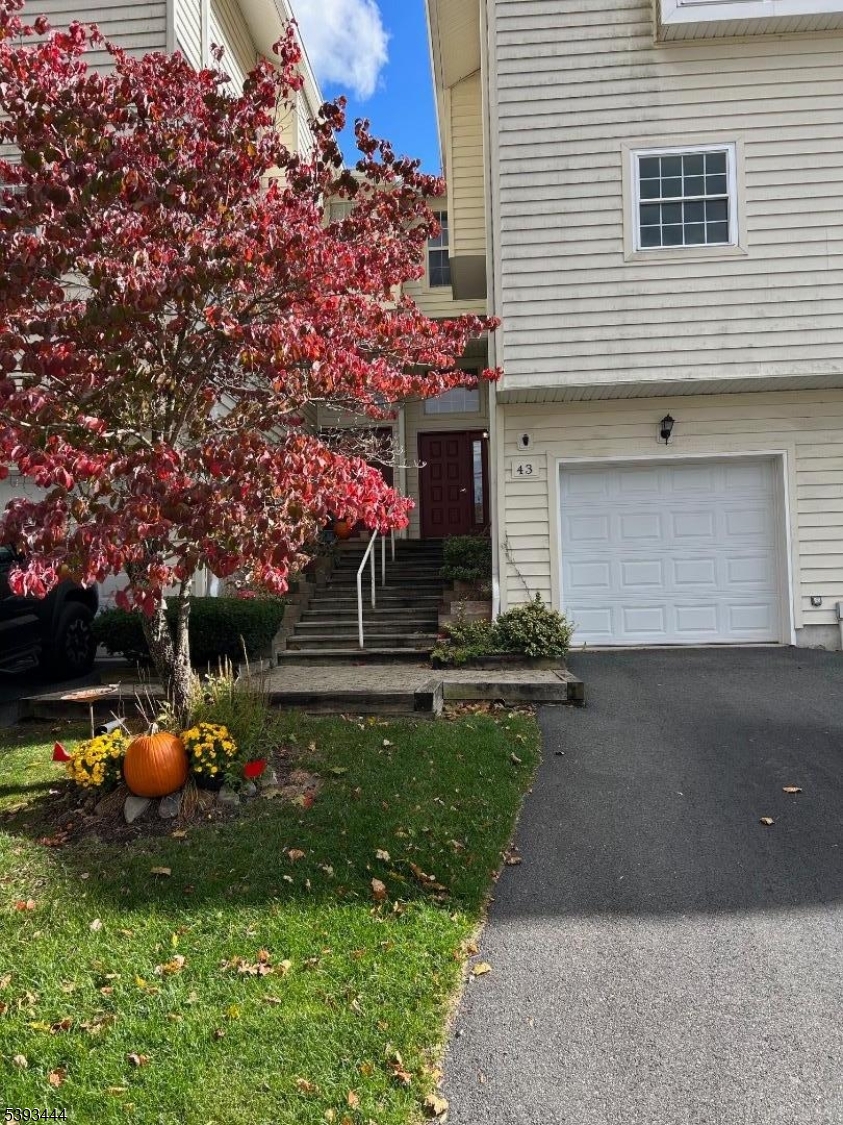 a front view of a house with swing and a garage