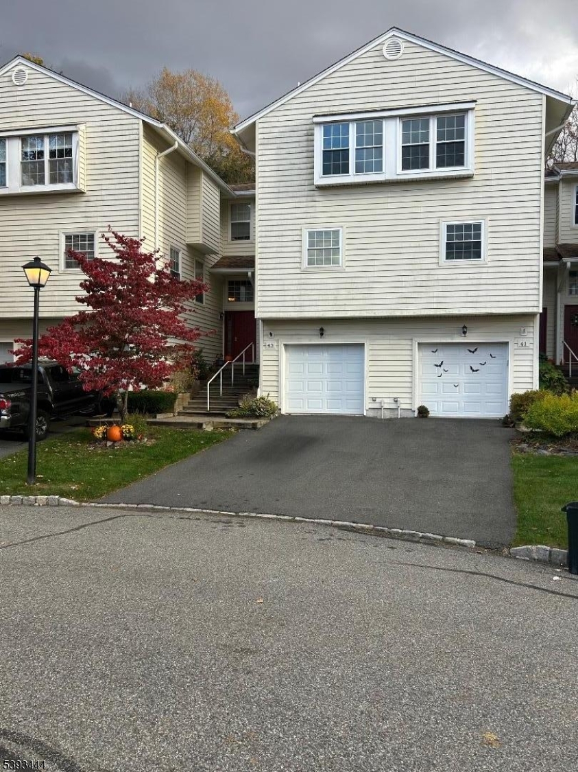 43 Rhea Run Newton, NJ 07860 - Photo 11 of 11 a front view of a house with a yard and garage