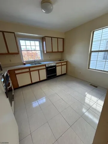 a spacious bedroom with a bed and a window