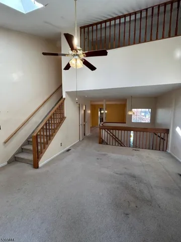 a view of an empty room with stairs