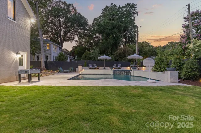 a view of a house with swimming pool and sitting area