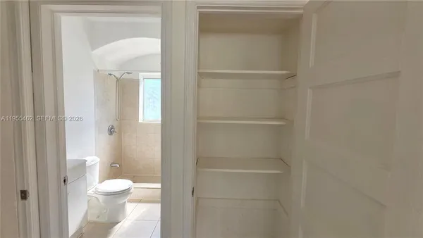 a white toilet sitting next to a bathroom sink
