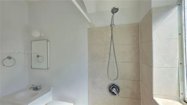 a bathroom with a glass shower door